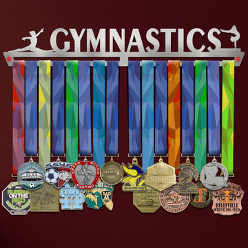 Gymnastics Medal Hanger Display FEMALE V1 showcasing up to 50 colorful medals on a brushed stainless steel rack with gymnast silhouettes.